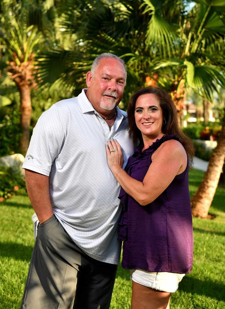 Smiling couple posing for a photo in a park